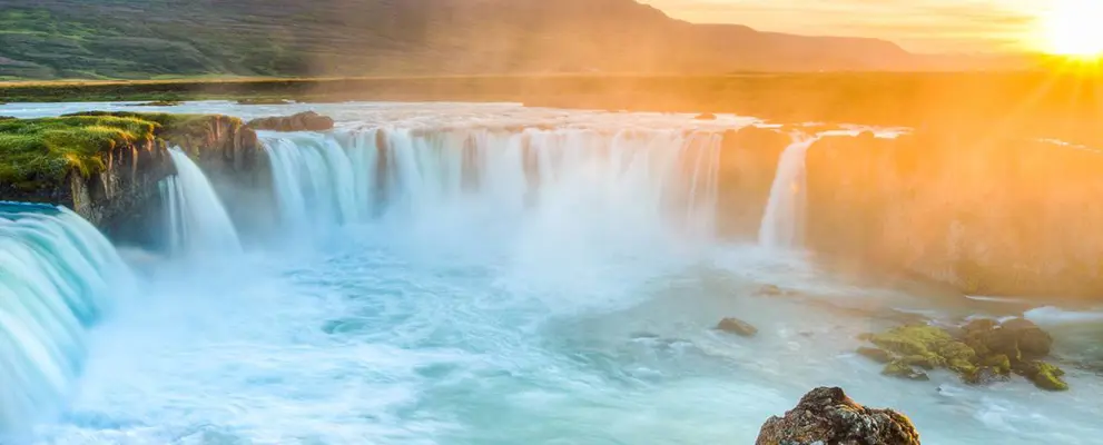 Sun setting over an Icelandic waterfall